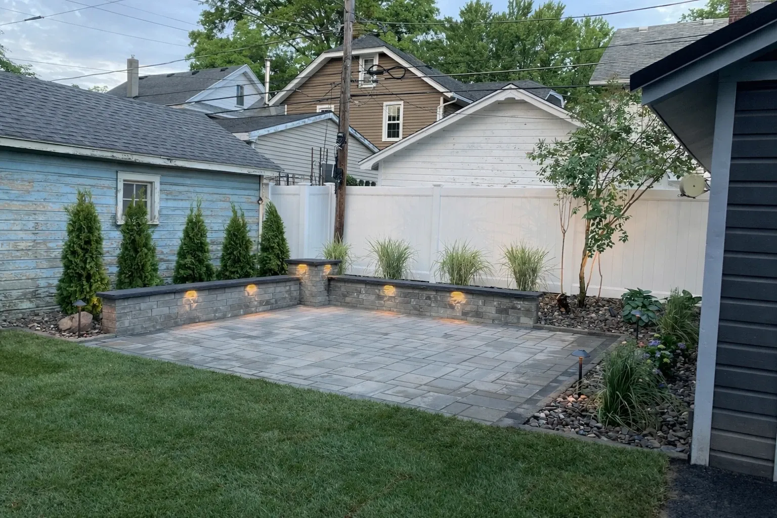 Illuminated patio and landscape at dusk