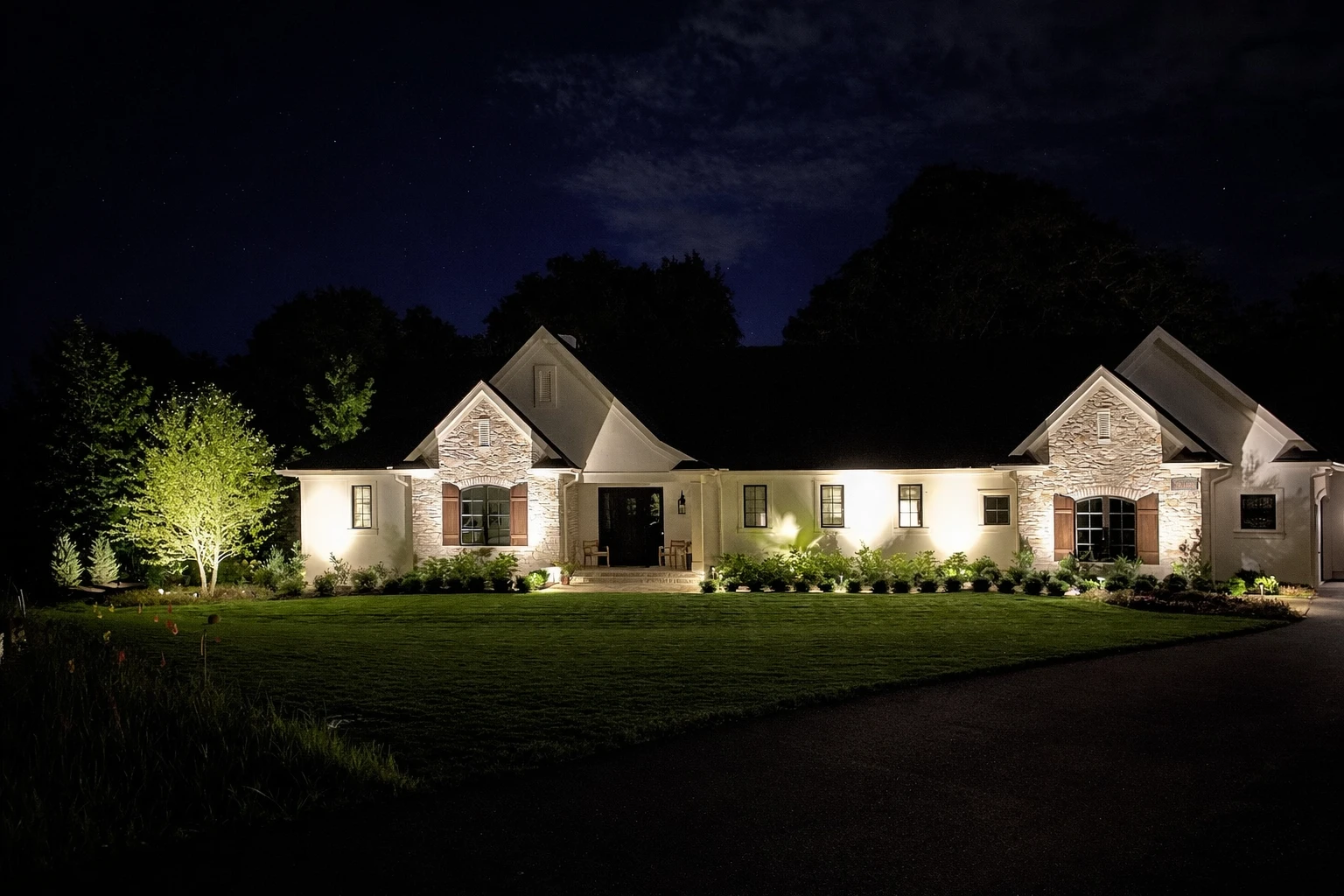 Professional landscaping in Rochester NY — lush lawn with landscape lighting
